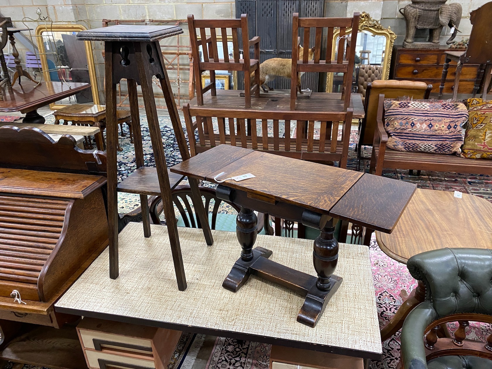 A 1920's small oak draw leaf occasional table, width 41cm, depth 29cm, height 44cm together with an Edwardian oak two tier plant stand